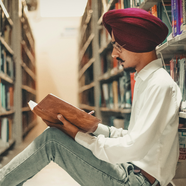 Student reading a book in the library