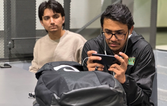 Students sit in the Nexus and play PUBG on their phones