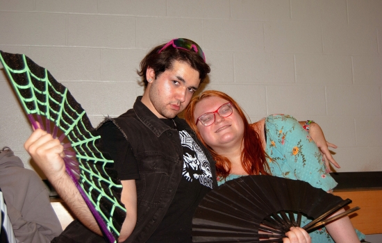 Two students posing with fans in the SLC
