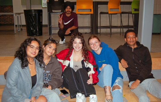 Crowd shot of smiling students sitting in the SLC tiered seating