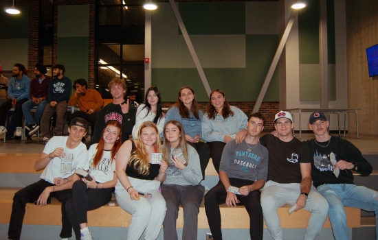 Crowd shot of smiling students sitting in the SLC tiered seating