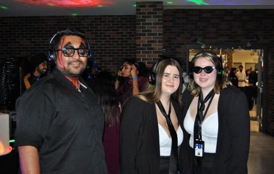 3 students in costume in the SLC