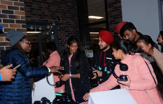 Students picking up their headphones for the event
