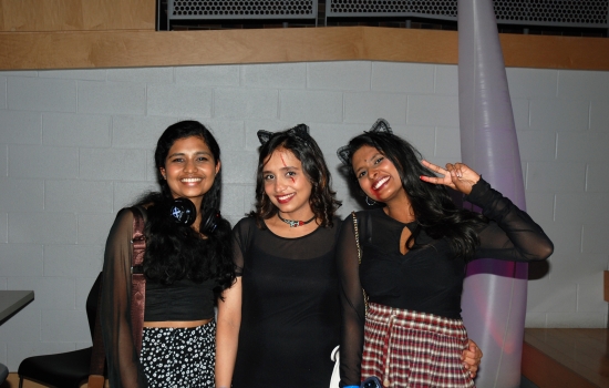 Three students smiling in the SLC