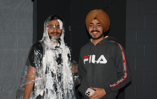 Pratham poses with Rishi, who is covered in whipped cream