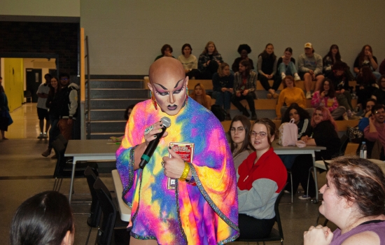 Drag queen Sabin speaks to the crowd through a microphone