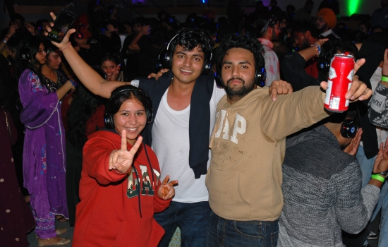 3 students posing for a photo on the dance floor