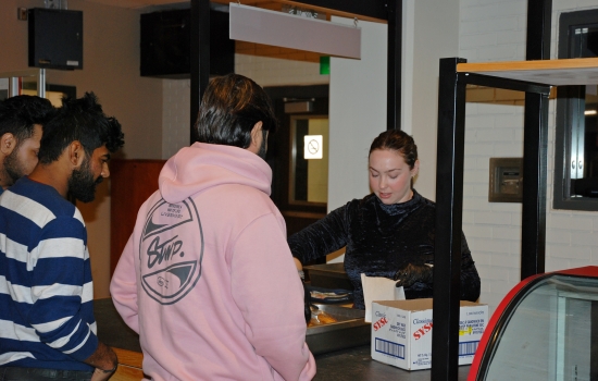 Natalie hands out treats at the Grab N' Go Kiosk