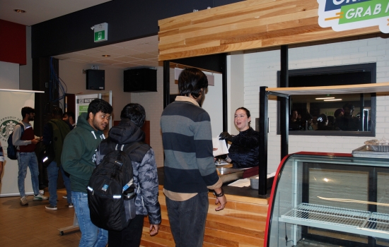 Natalie hands out treats at the Grab N' Go Kiosk