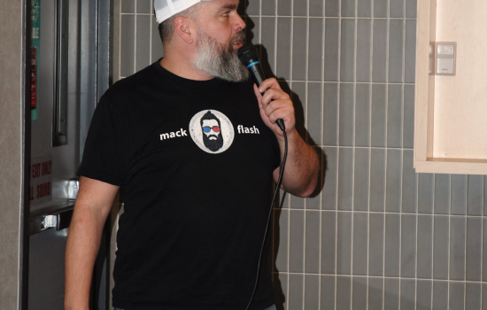Mack Flash Trivia host speaking into a microphone