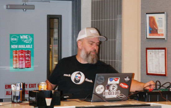Mack Flash Trivia host changing the question on his laptop