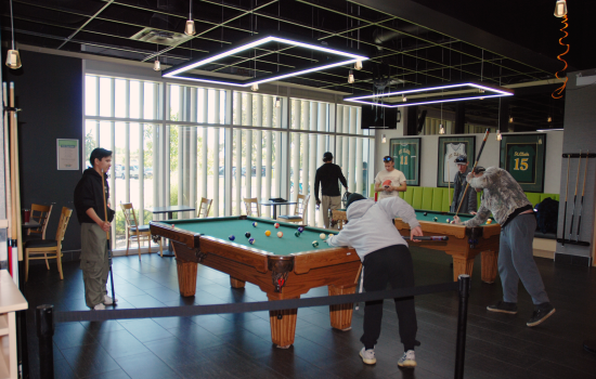 A group of students playing pool at Griff's