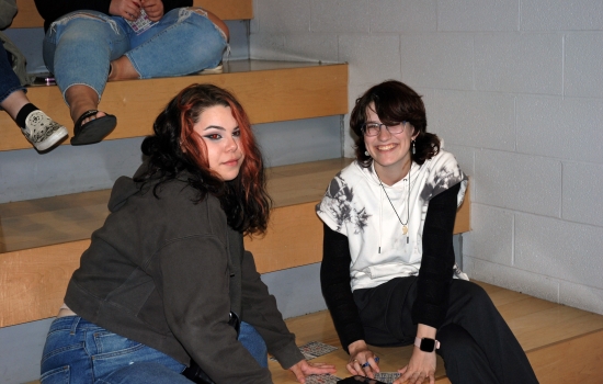 Two students sitting on tiered seating in the SLC