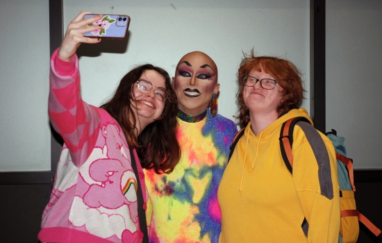 Two students smile and take a selfie with Sabin