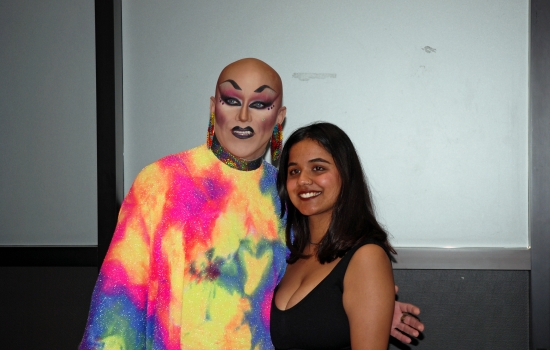 A student smiles while posing for a photo with Sabin