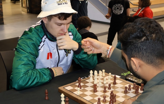 Rishi vs student chess game on the SLC stage