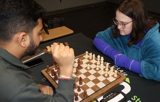 Rishi vs student chess game on the SLC stage