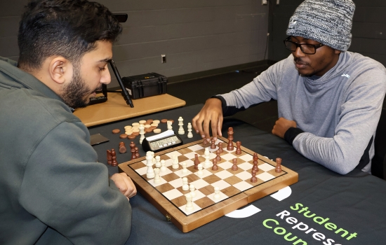 Rishi vs student chess game on the SLC stage