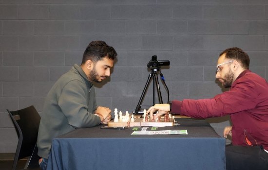 Rishi vs student chess game on the SLC stage