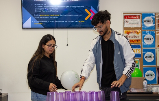 A student prepares to play the Cup Tower game