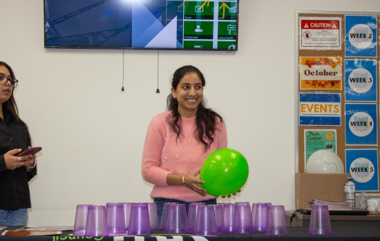 A student prepares to play the Cup Tower game