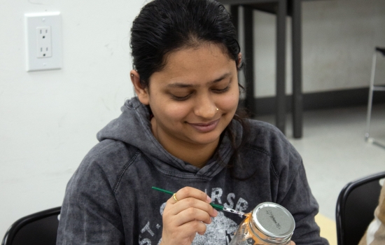 SRC staff member Karishma painting a jar