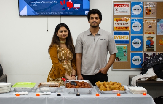 Karishma and her student staff stand at the table ready to serve students
