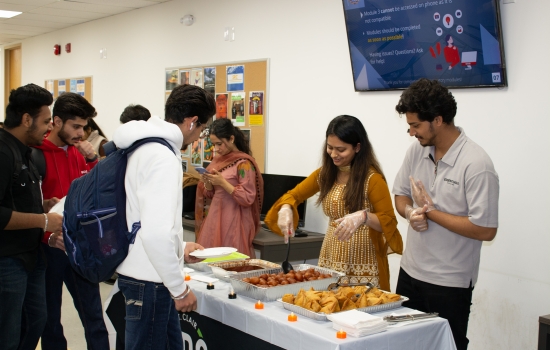 Karishma and her student staff serve students free snacks