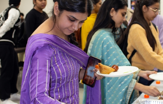 A students in line being served snacks