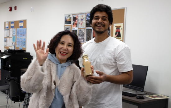 Kunal poses with a student who won a Starbucks beverage