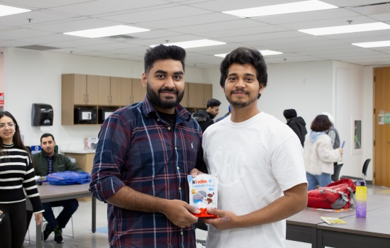 Kunal poses with a student who won candy