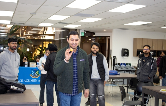 A student prepares to take his shot while others watch