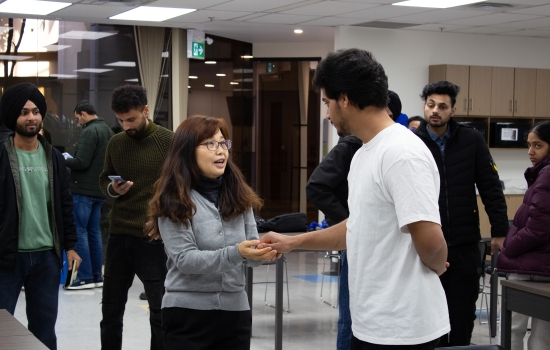 Kunal hands the balls over to a student