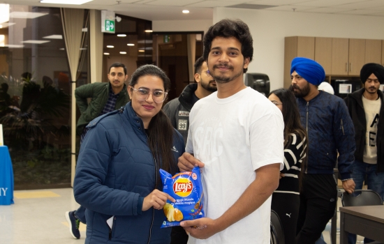 Kunal poses with a student who won chips