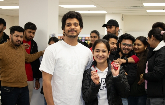 Kunal poses with a student who won chocolate