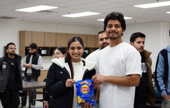 Kunal poses with a student who won chips