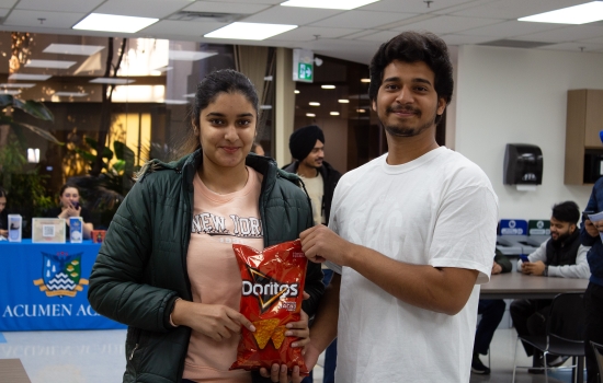 Kunal poses with a student who won Doritos