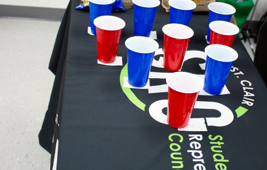 The table set up with red and blue cups in a pyramid formation