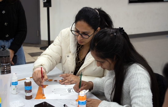 Two students work on their art pieces