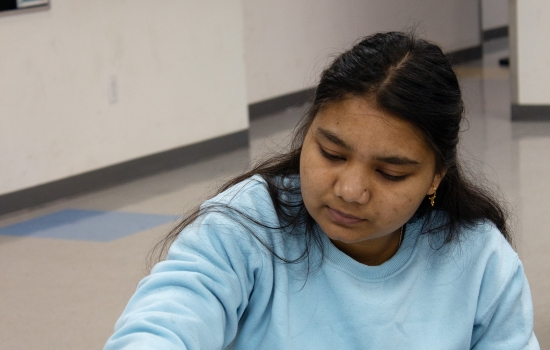 A student working on her palm art