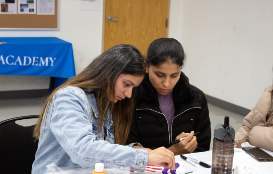 Two students focus on their artwork