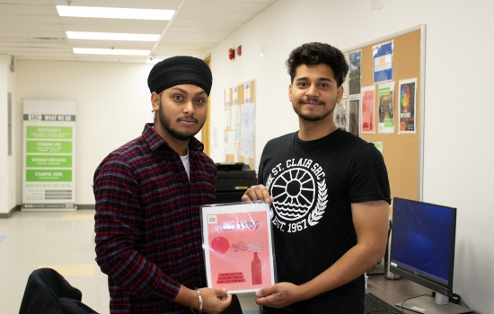  Kunal and a student pose with the event flyer
