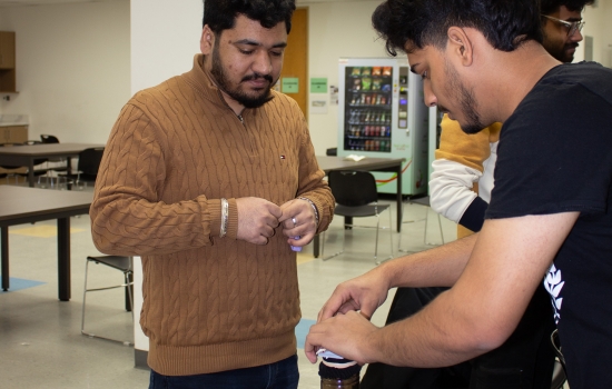 A student prepares for their turn to blow the cards