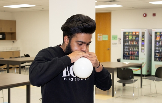 A student blows up their balloon 