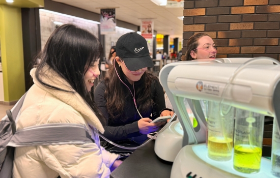 2 students and Natalie try the oxygen bar