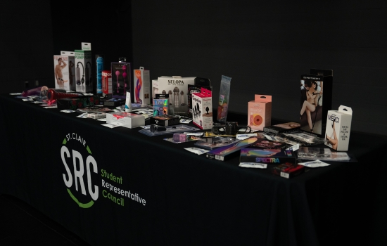 A table with an SRC table cloth covered in sex toy prizes