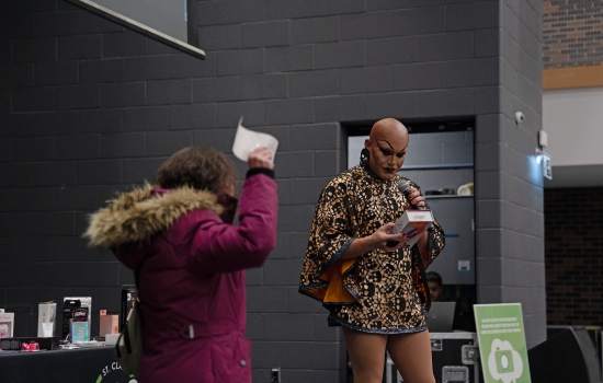 Sabin reads the back of a sex toy before awarding it to the winner