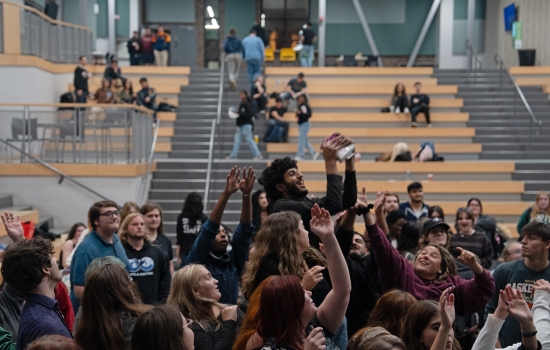 Students gather in front of the stage and all try to catch sex toys that are thrown