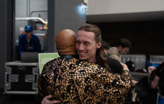 Sabin hugs a student