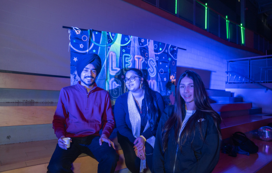 Board members pose for the camera with a student
